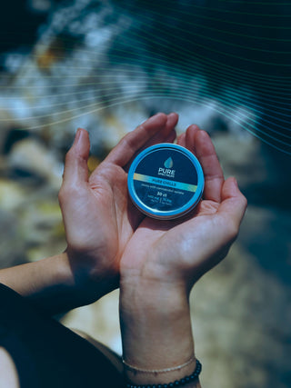 Close-up of Pure Chill CBD mints held in cupped hands, Pure Spectrum CBD isolate mints
