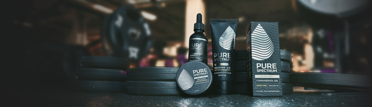 Black Label CBD product lineup in gym setting with weights in background
